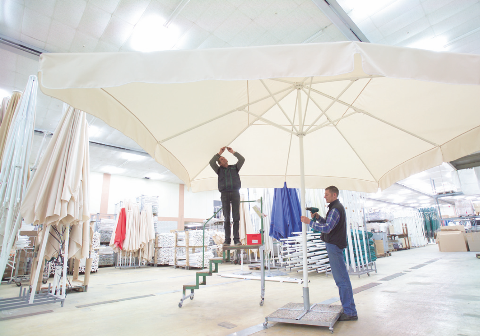 Technicians erecting a large professional sunshade